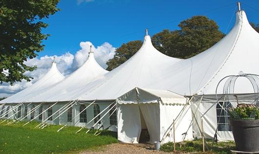 a line of portable restrooms in a shaded area, offering a comfortable experience for users in Sabin